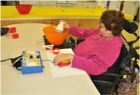 Picture: woman using a mixer with adapted switch