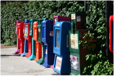 Picture: newspaper boxes along a sidewalk